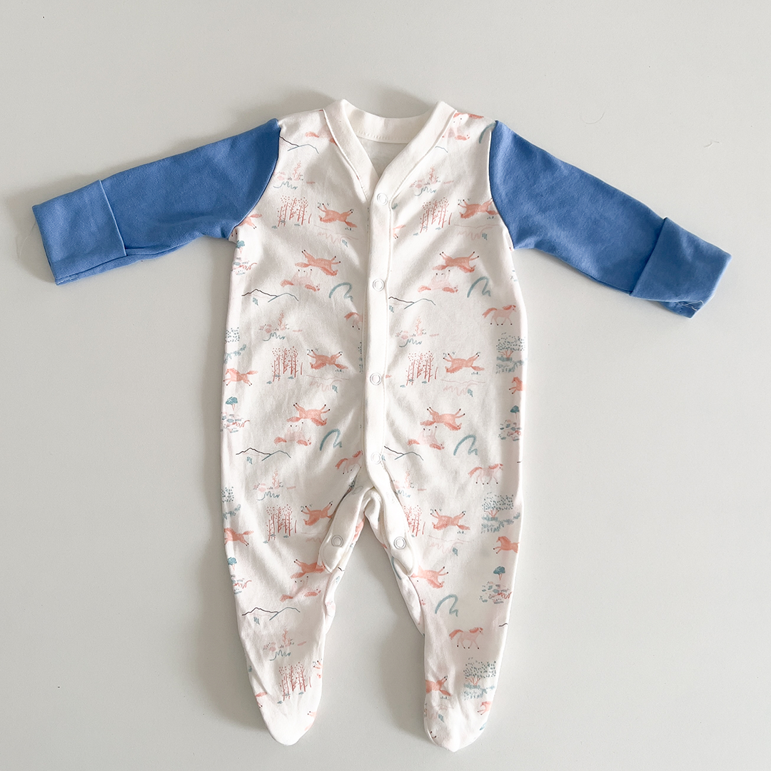 White and blue patterned sleepsuit