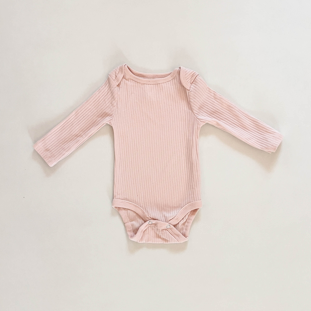 TENDER PEACH RIBBED ONESIE