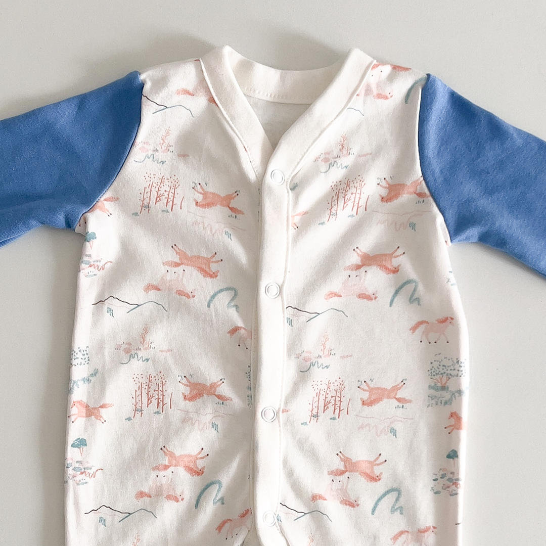 White and blue patterned sleepsuit