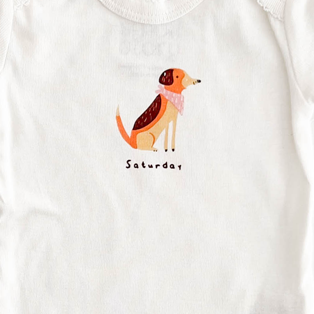 SATURDAY PRINT WHITE ONESIE