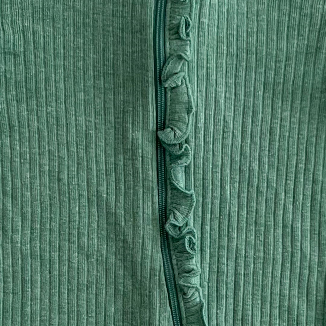 Green ribbed ruffles on front sleepsuit