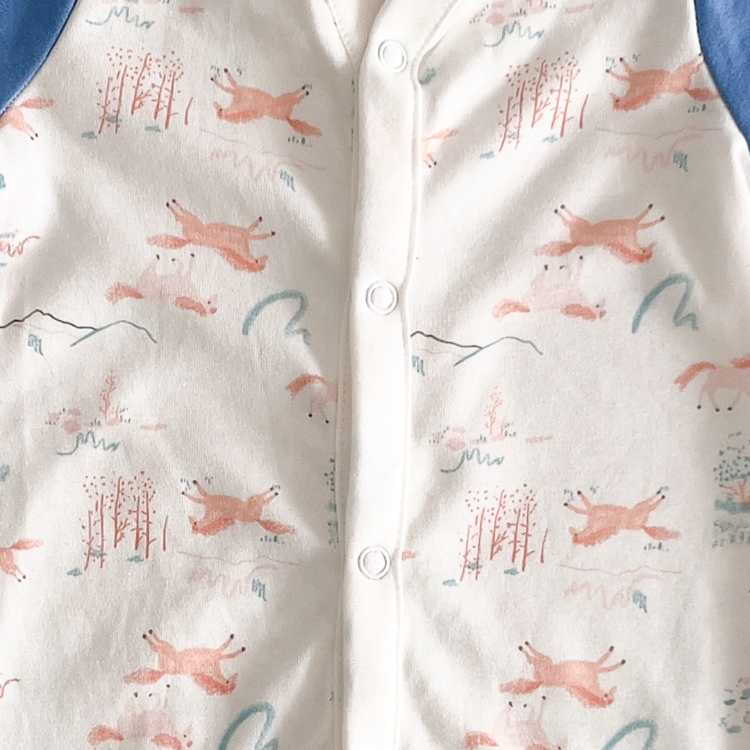 White and blue patterned sleepsuit
