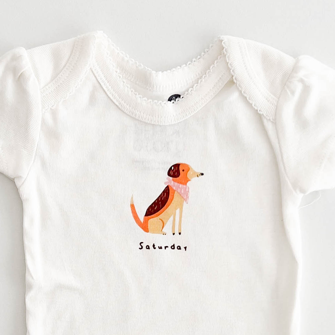 SATURDAY PRINT WHITE ONESIE