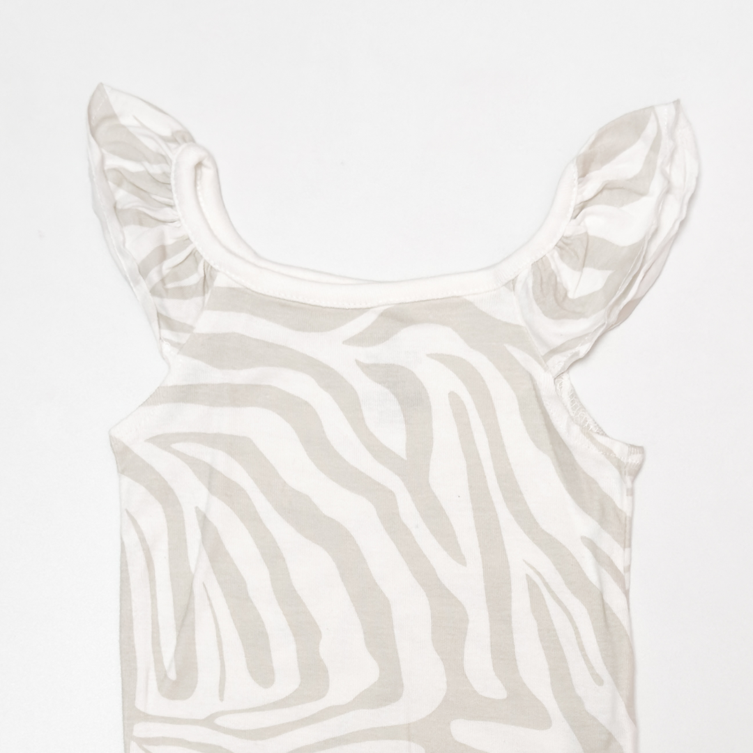 CREAM PATTERNED RUFFLE ONESIE