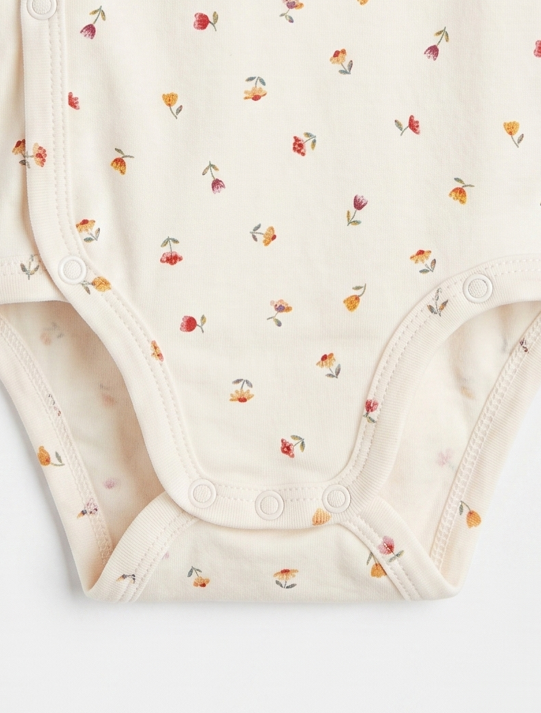 OFF WHITE WRAPOVER FLORAL ONESIE