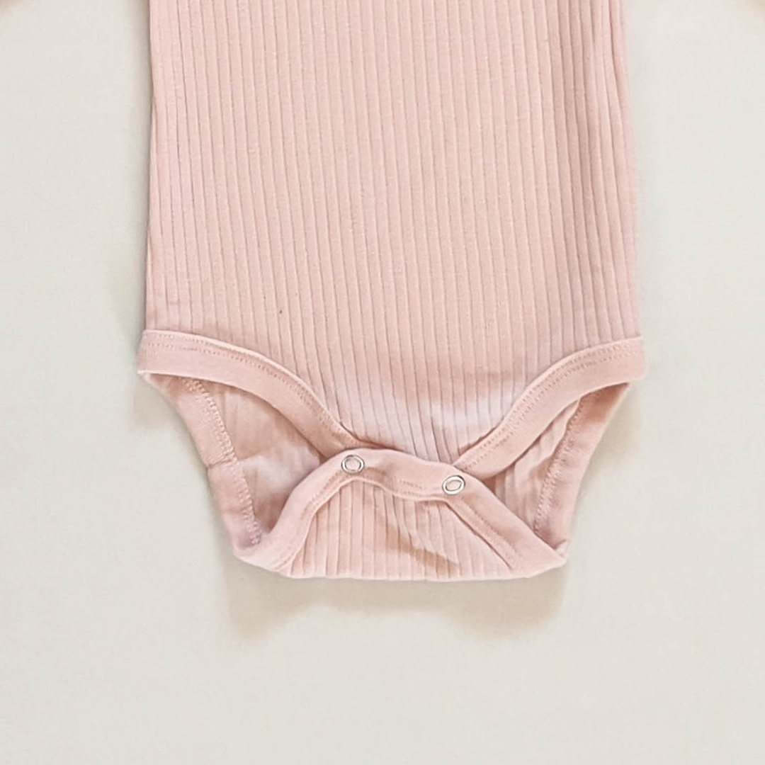 TENDER PEACH RIBBED ONESIE
