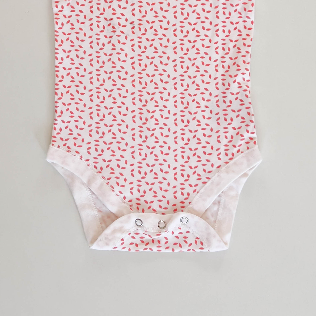 RED PATTERNED SLEEVLESS ONESIE